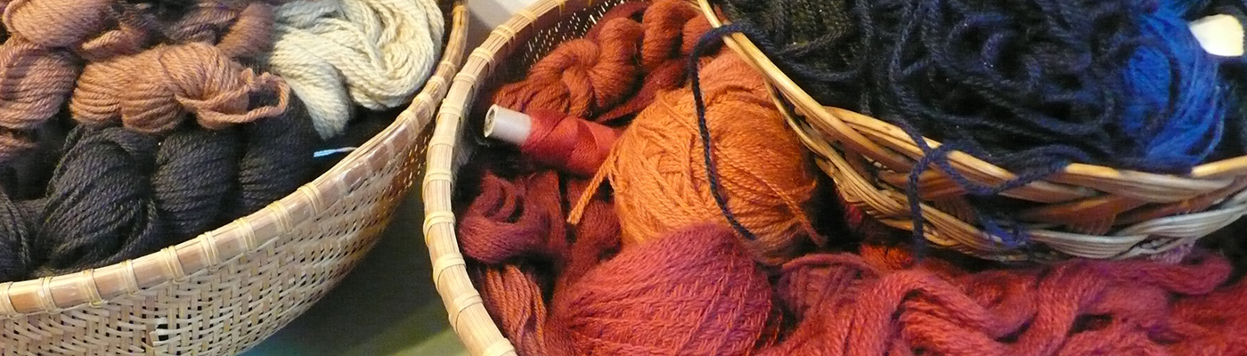 baskets of multicolored rug yarn